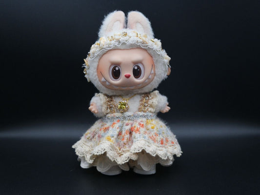 A Labubu figure wearing a white wedding dress, bridal headband, and necklace