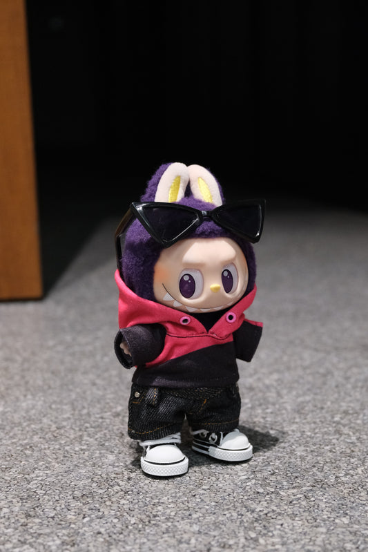 A Labubu figure wearing a 4-piece outfit featuring a pink and black layered hoodie, dark denim jeans, sunglasses, and black and white sneakers.