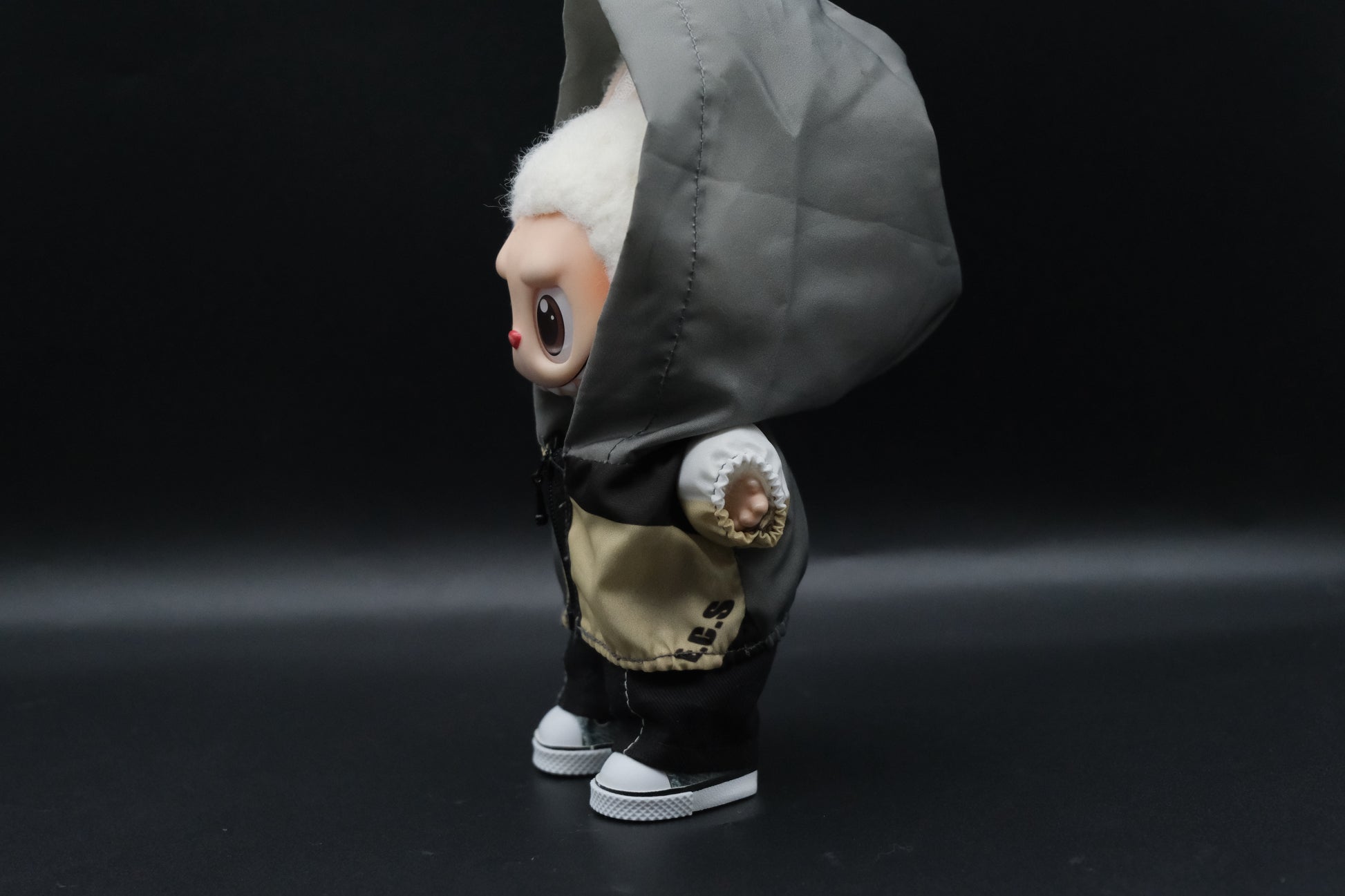  a Labubu figure wearing a functional windbreaker outfit, black pants and shoes