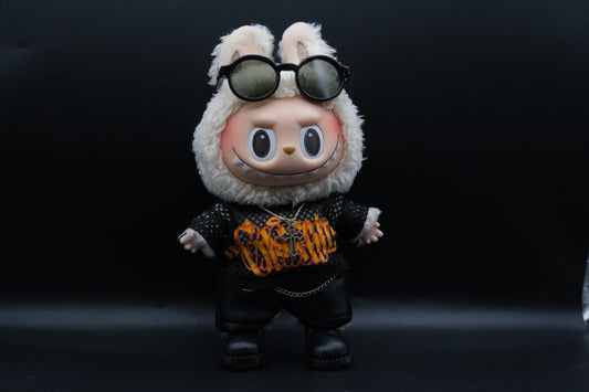 labubu wearing sunglasses and a black outfit with orange text on a dark background