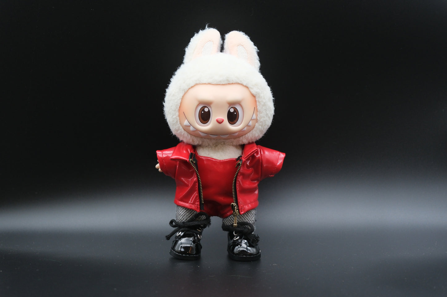 LABUBU plush doll wearing a handmade leather jacket, vest, and fishnet stockings, inspired by Blackpink's Lisa