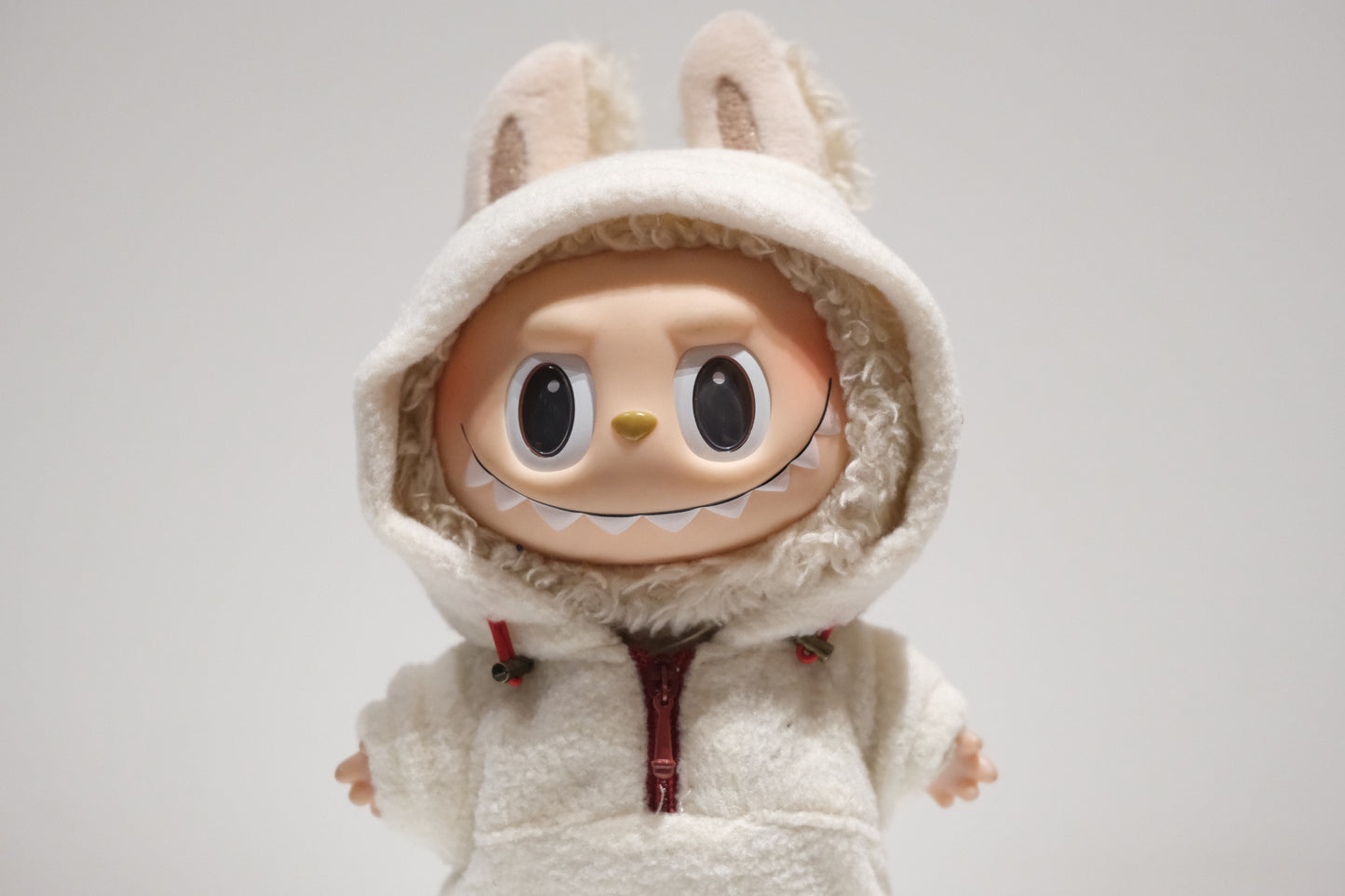 Labubu figure wearing a 3-piece teddy fleece hoodie and pants cozy winter outfit with sneakers
