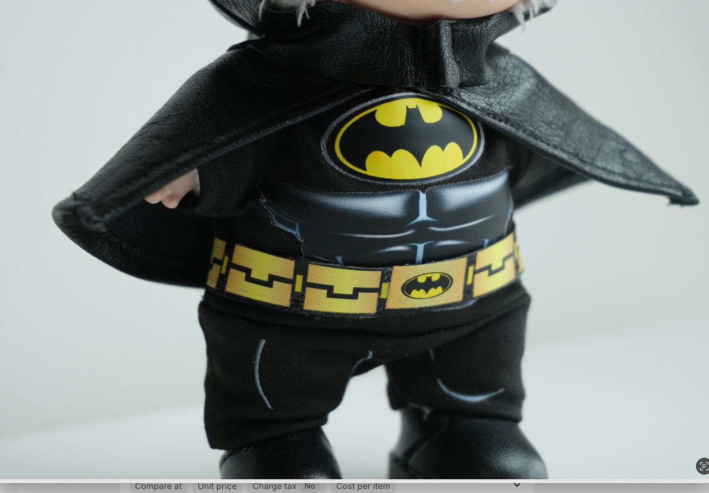 labubu wearing a Batman costume with cape and logo 