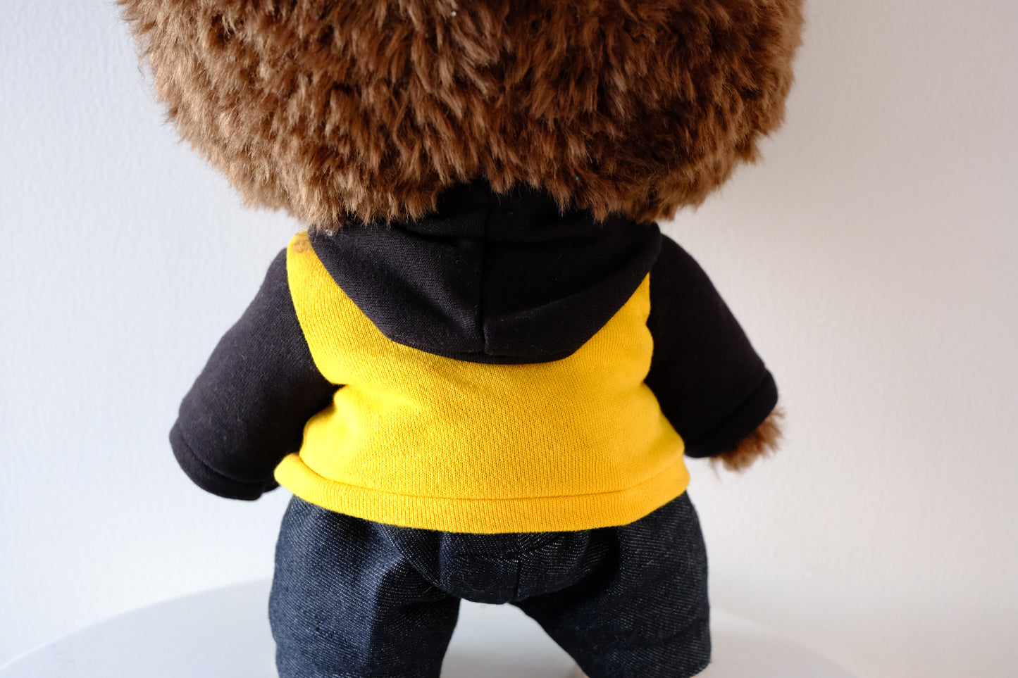 back view of 38cm Labubu figure wearing a blue Let's Checkmate series hoodie and structured denim jeans