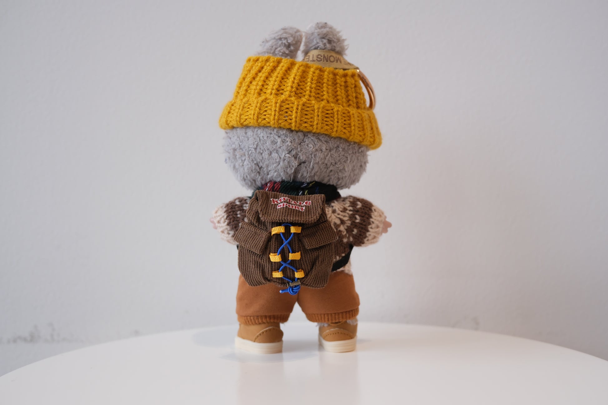 Labubu figure wearing a 5-piece winter knit outfit, including a Fair Isle sweater and yellow beanie