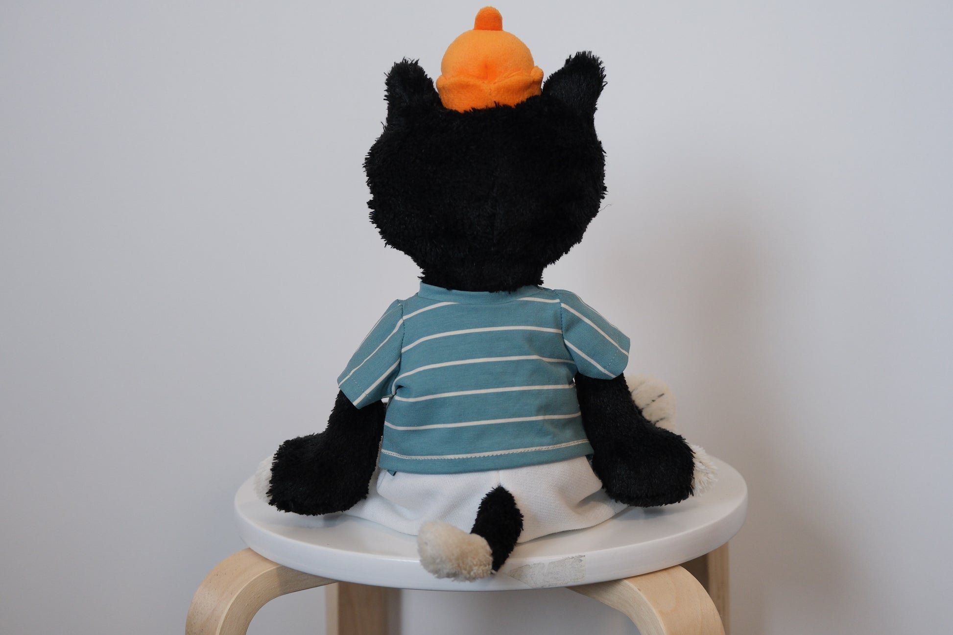 back view of jellycat jack wearing a striped shirt  a white pants