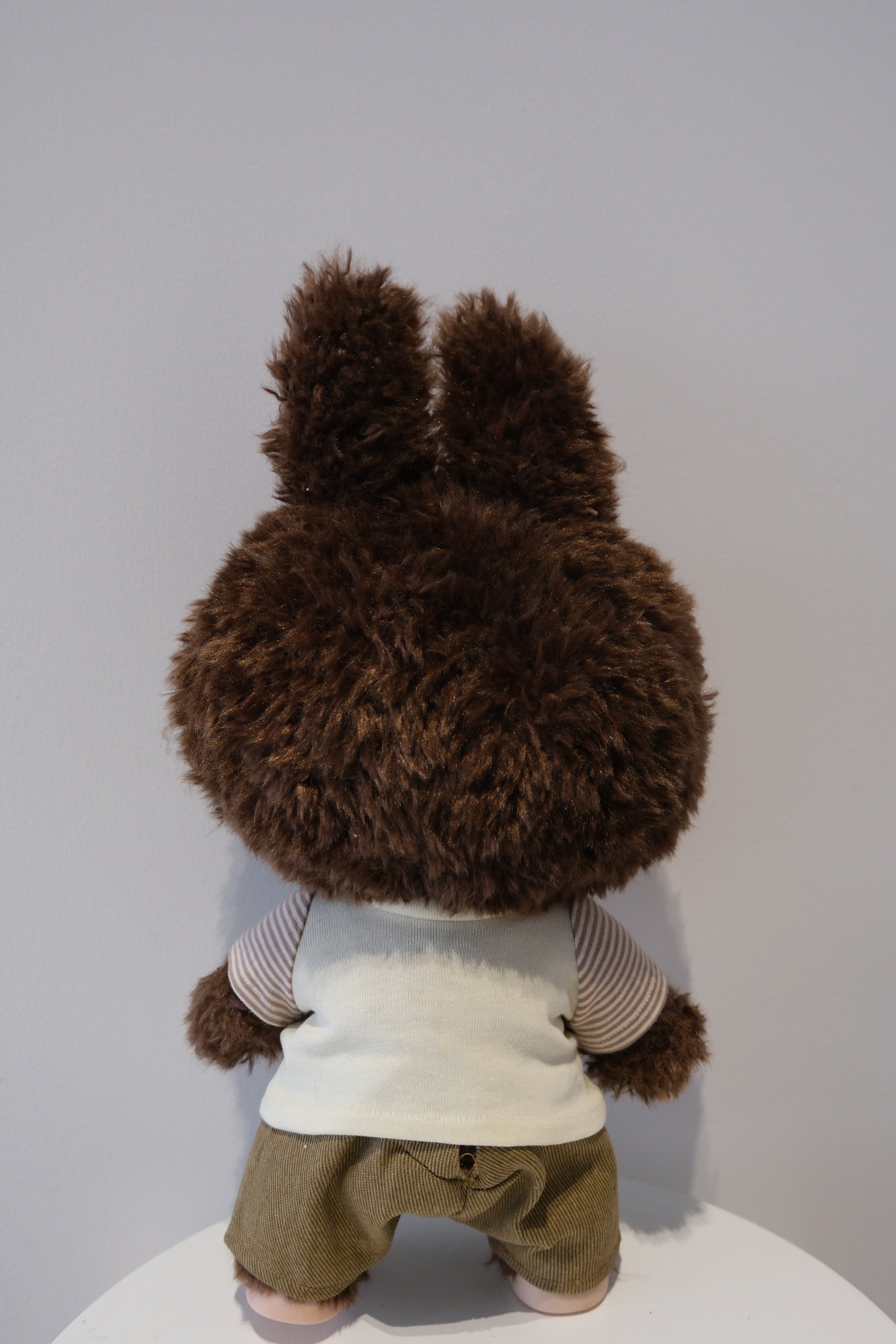 back view of A cute Labubu figure dressed in a 2-piece child-style outfit from the Let's Checkmate series, featuring colorful paneled joggers and a playful graphic t-shirt.