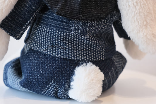 Close-up of unique geometric woven pattern on indigo fabric of the Jellycat Bunny outfit