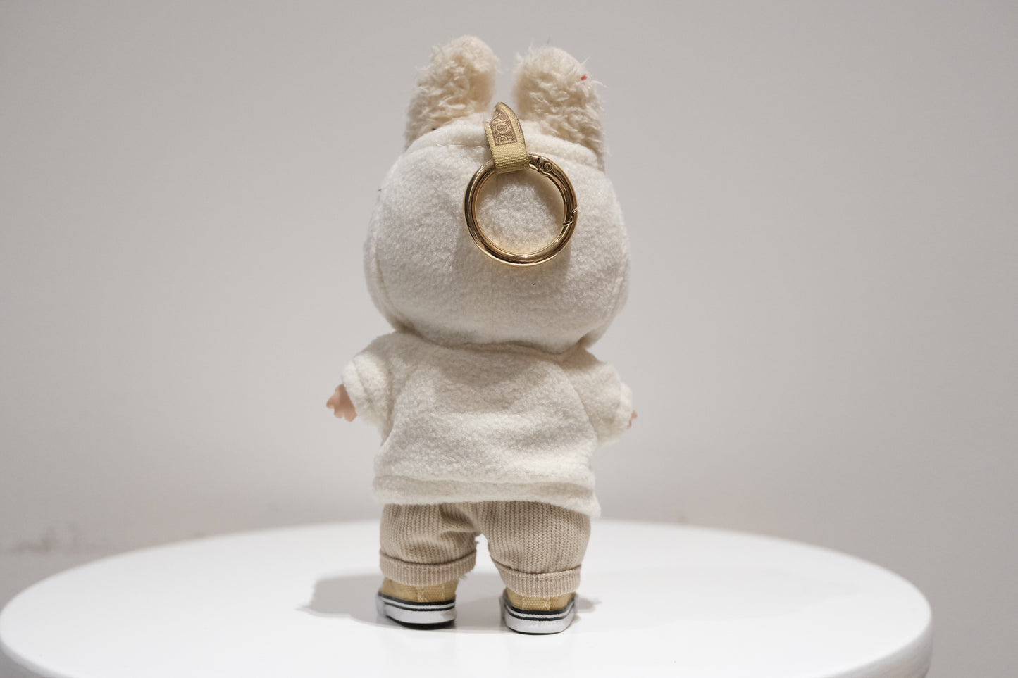 back view of Labubu figure wearing a 3-piece teddy fleece hoodie and pants cozy winter outfit with sneakers