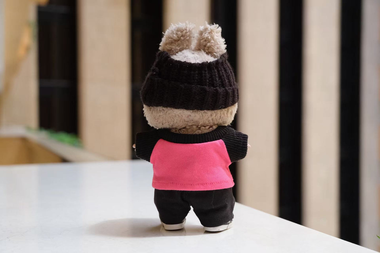 A Labubu figure wearing a 5-piece athletic streetwear outfit, including a graphic T-shirt, headband, and a silver necklace.