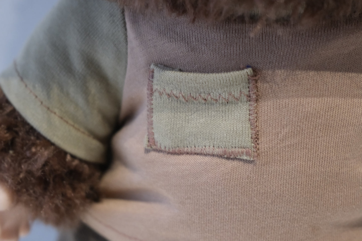 Close-up of labubu t-shirt textured fabric patch on a garment 