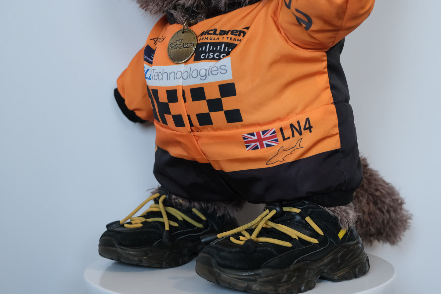 58cm Mega Zimomo wearing a McLaren F1 racing jumpsuit in orange and black