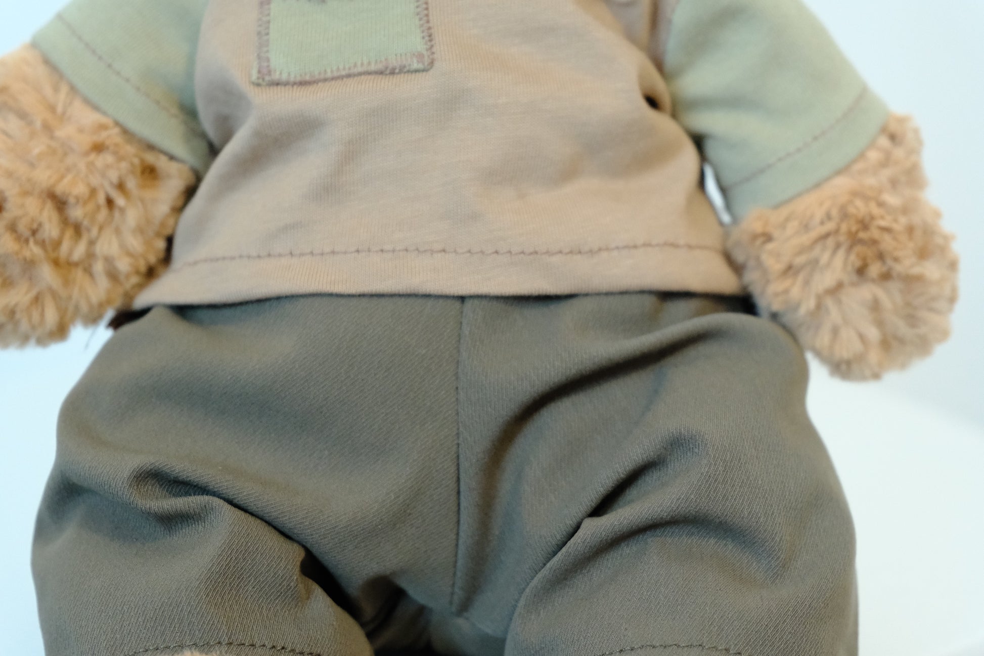 Close-up showing the soft fabric and flexible waistband of the pants on a Jellycat Bear.