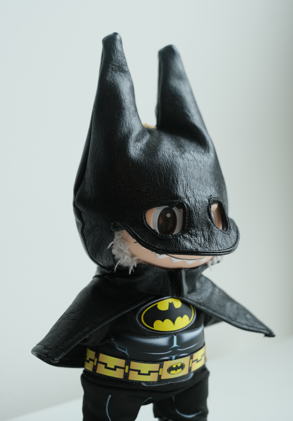 close up of Batman-themed labubu figure with cape and mask