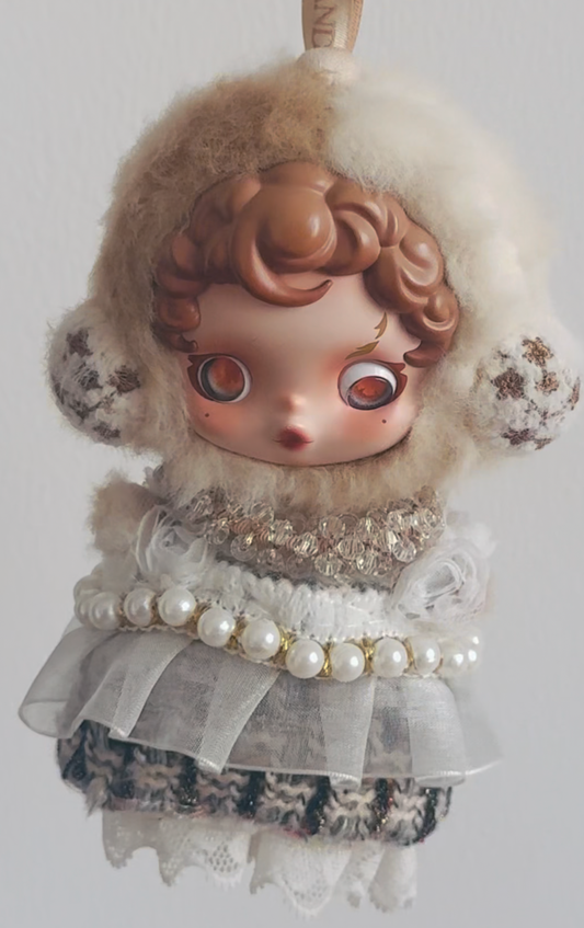A Skullpanda figure wearing a custom-made, white feather dress and a fluffy white cap with a headband.