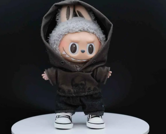 A LABUBU doll wearing a handmade grey hoodie with a black skull graphic print