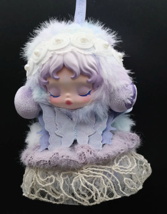 A Skullpanda figure wearing a custom-made, purple butterfly dress and a matching headband.

