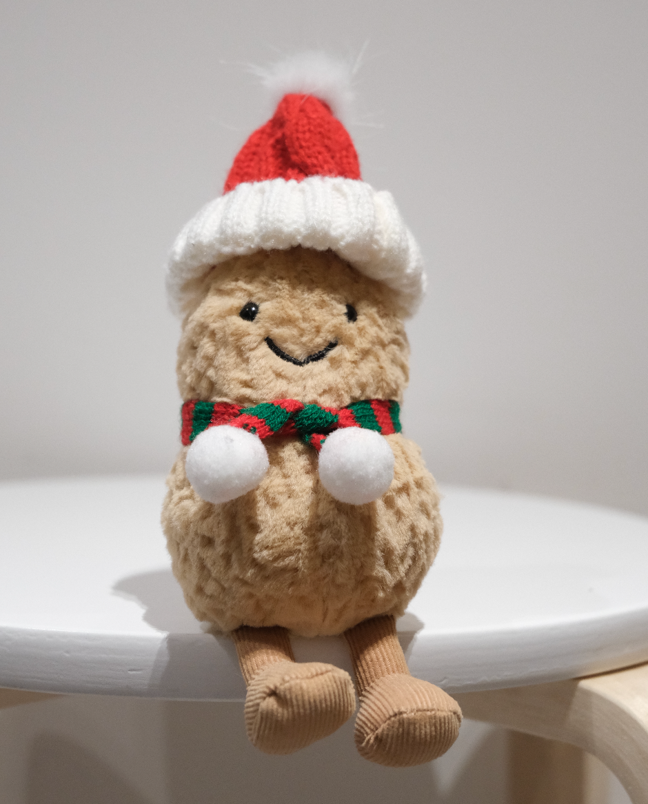 Jellycat Amuseables Peanut wearing a 2-piece festive Christmas outfit including a Santa hat and red scarf.