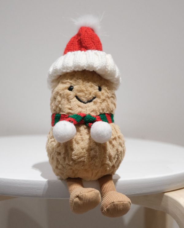 Jellycat Amuseables Peanut wearing a 2-piece festive Christmas outfit including a Santa hat and red scarf.