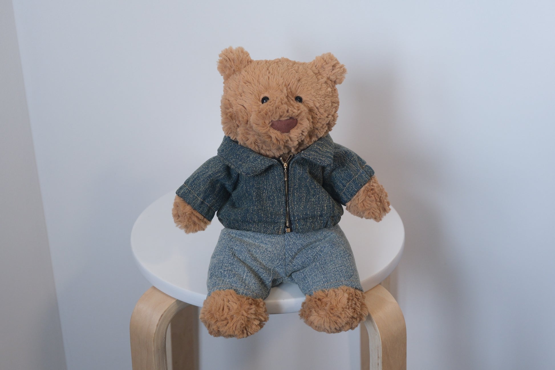 Jellycat Bartholomew Bear plush wearing a 2-piece double denim outfit including a trucker jacket and matching jeans