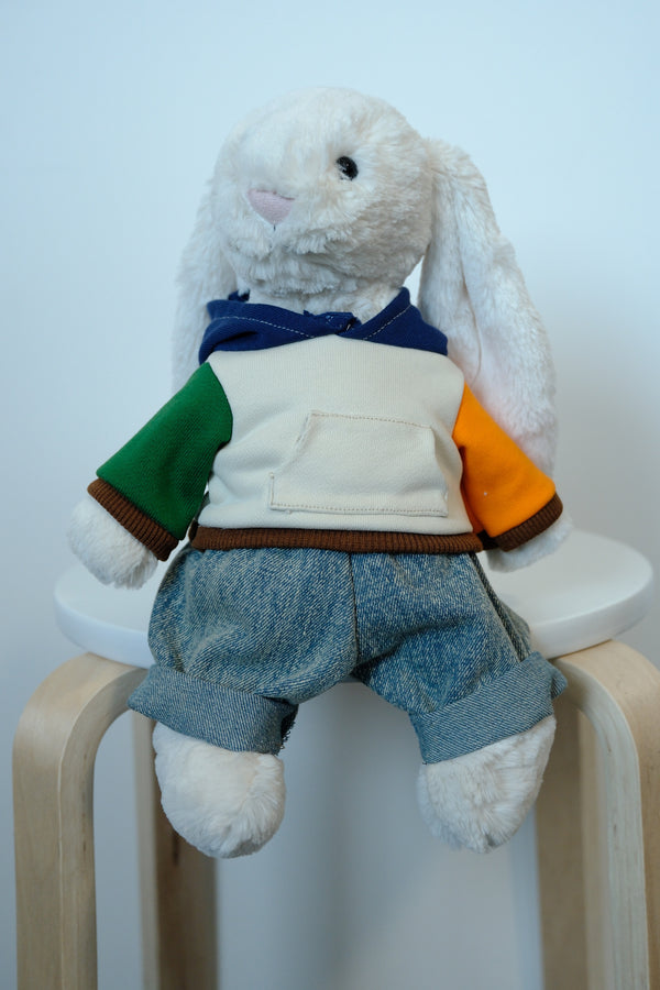 Jellycat Bashful Bunny plush wearing a 2-piece urban outfit with a gray hoodie and blue denim jeans.