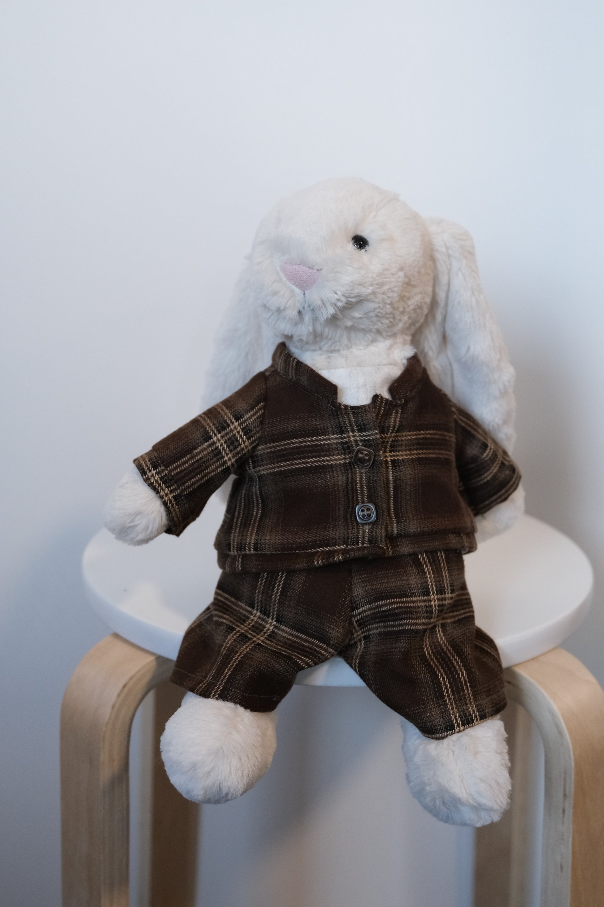 Jellycat Bashful Bunny wearing a cream quilted jacket and matching trousers spring outfit.