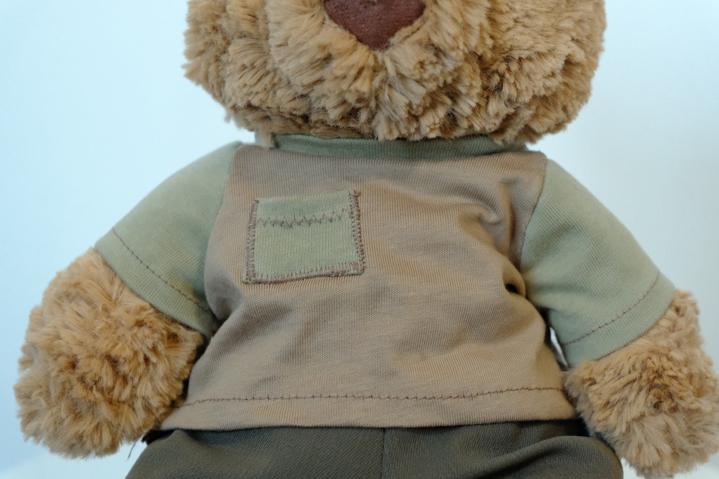 Close-up showing the soft fabric and flexible waistband of the pants on a Jellycat Bear.