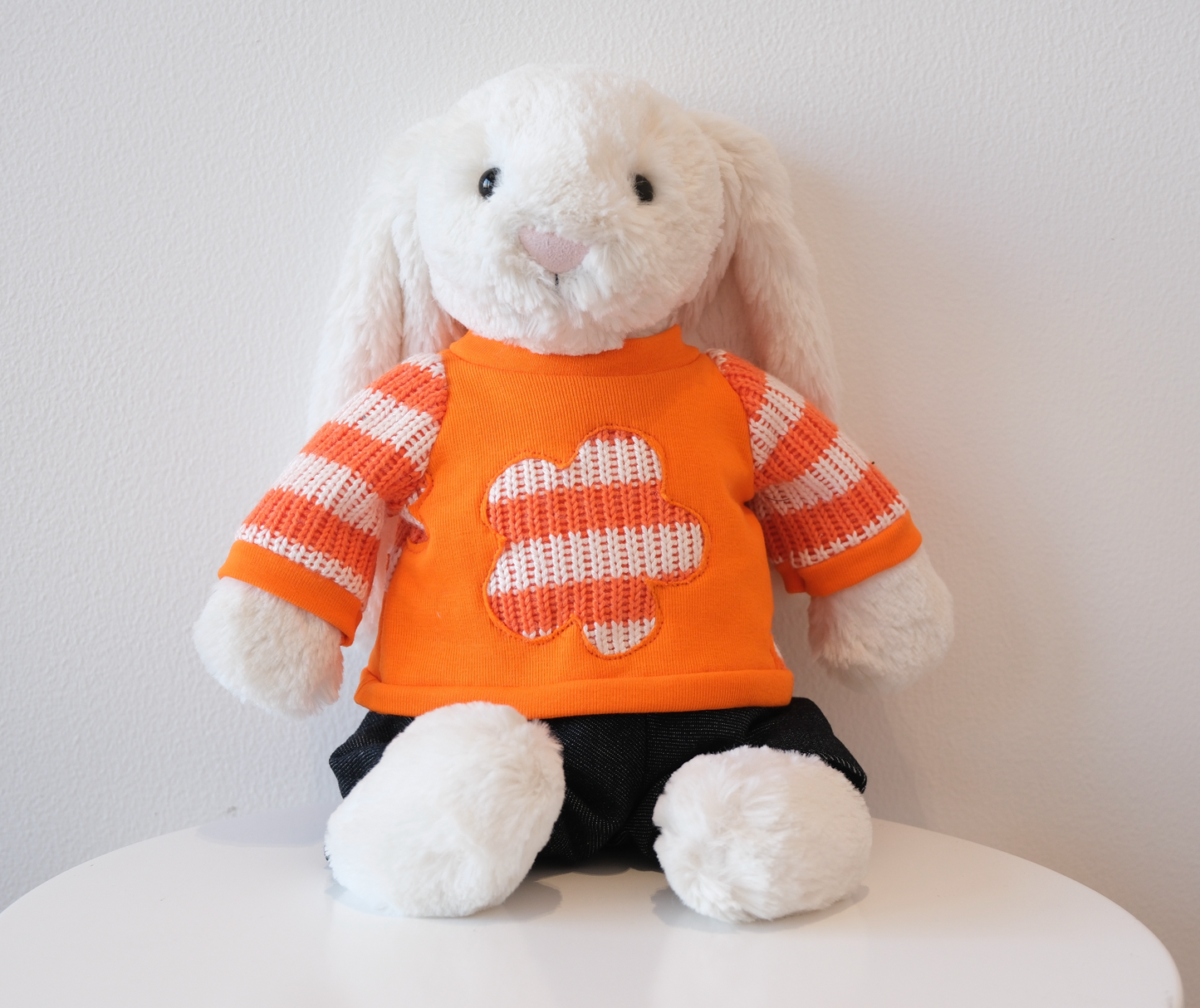 Jellycat Bashful Bunny wearing a 2-piece cozy loungewear outfit with a miniature crewneck sweatshirt and matching pants.