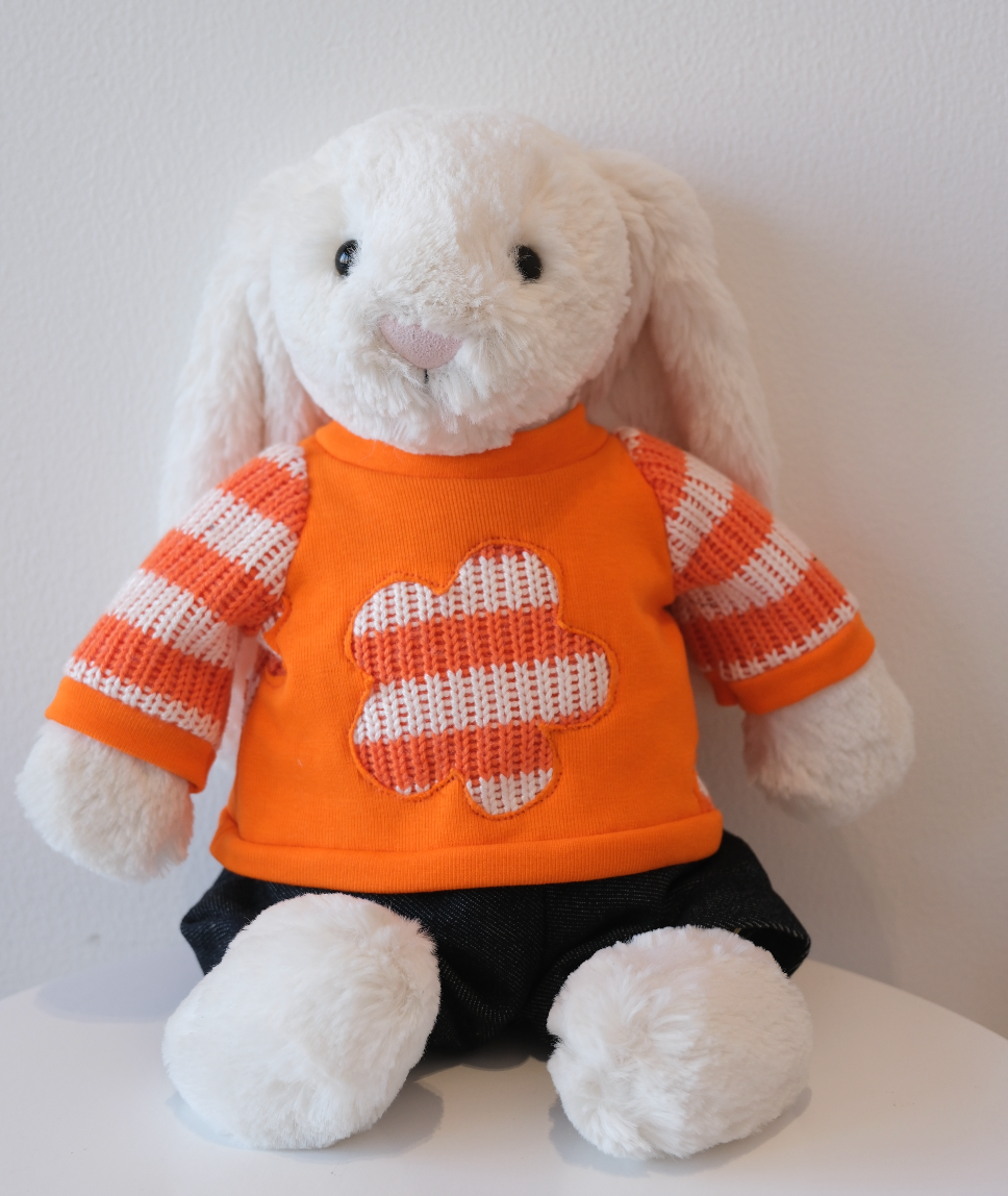 Jellycat Bashful Bunny wearing a 2-piece cozy loungewear outfit with a miniature crewneck sweatshirt and matching pants.