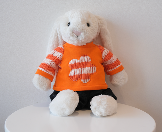 Jellycat Bashful Bunny wearing a 2-piece cozy loungewear outfit with a miniature crewneck sweatshirt and matching pants.