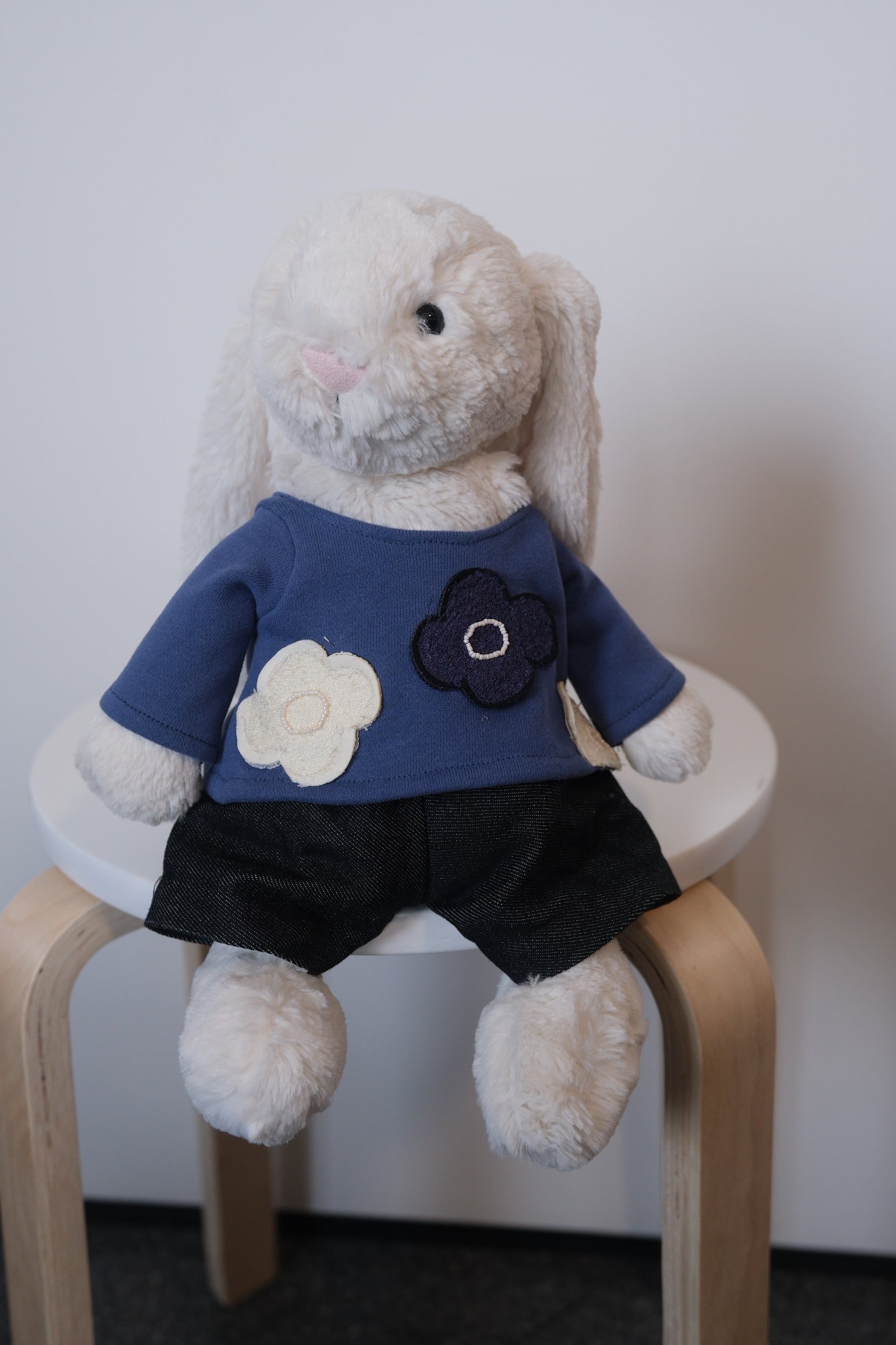 Jellycat Bashful Bunny wearing a 2-piece minimalist casual outfit with a simple T-shirt and matching pants.