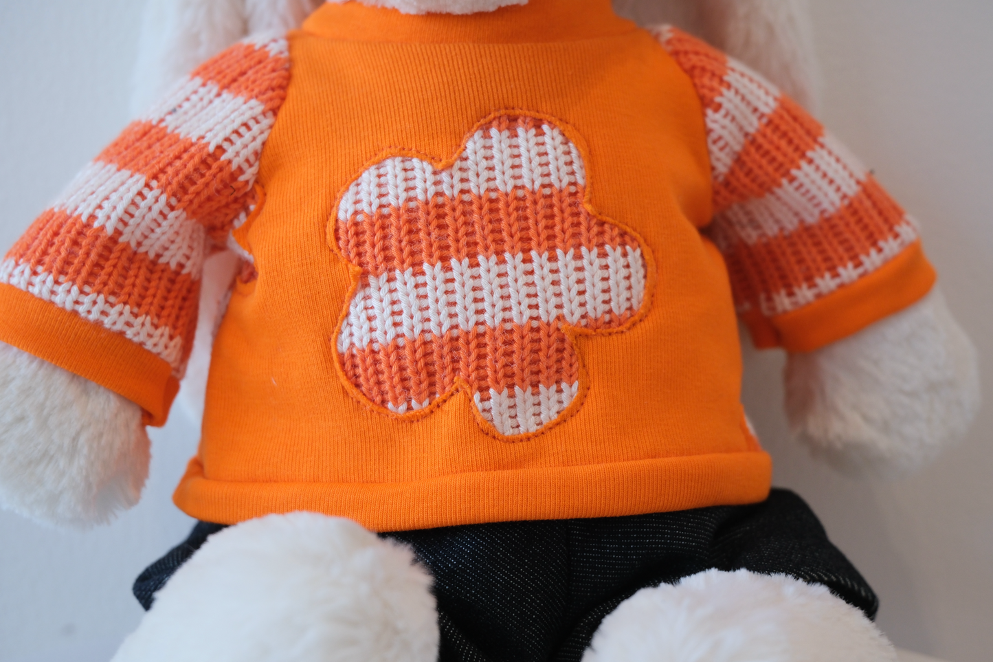 Close-up of the miniature soft fabric crewneck sweatshirt detail on a Jellycat Bunny doll.
