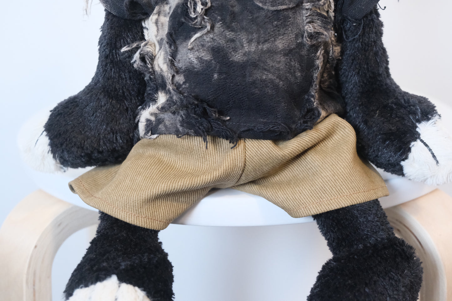 Close-up of the miniature designer T-shirt and pants set, highlighting the premium fabric and fit on the Jellycat Jack.