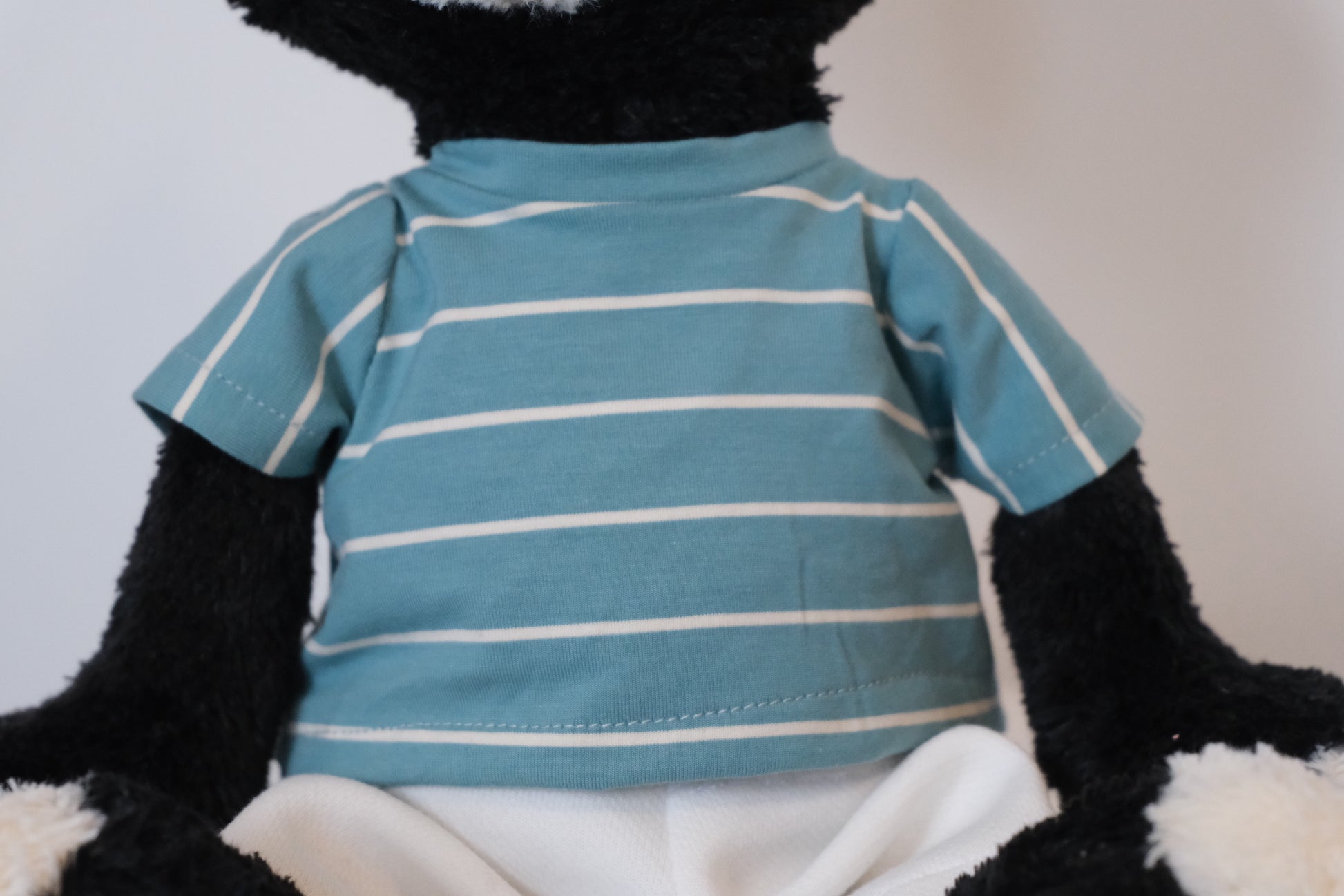 Close-up detail of the high-quality stitching and fabric of the T-shirt for the Jellycat Jack mascot