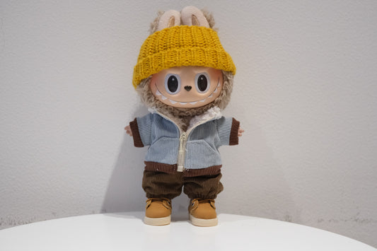 Labubu figure wearing a 4-piece urban streetwear outfit with a black corduroy jacket, beanie, pants, and sneakers.