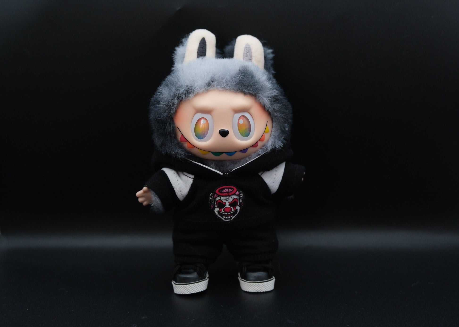 A trendy Labubu designer toy figure wearing a black and white hoodei, pants and black shoes
