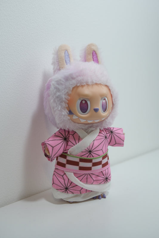 Labubu figures wearing three different Demon Slayer inspired cosplay outfits: Nezuko