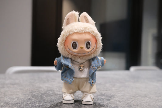 Labubu figure wearing a 5-piece outfit: light blue denim jacket, white tee, white leather shorts, sun necklace, and sneakers
