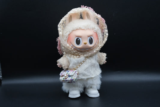 A Labubu figure wearing a white designer hoodie outfit, white pants and shoes, and a crossbody bag