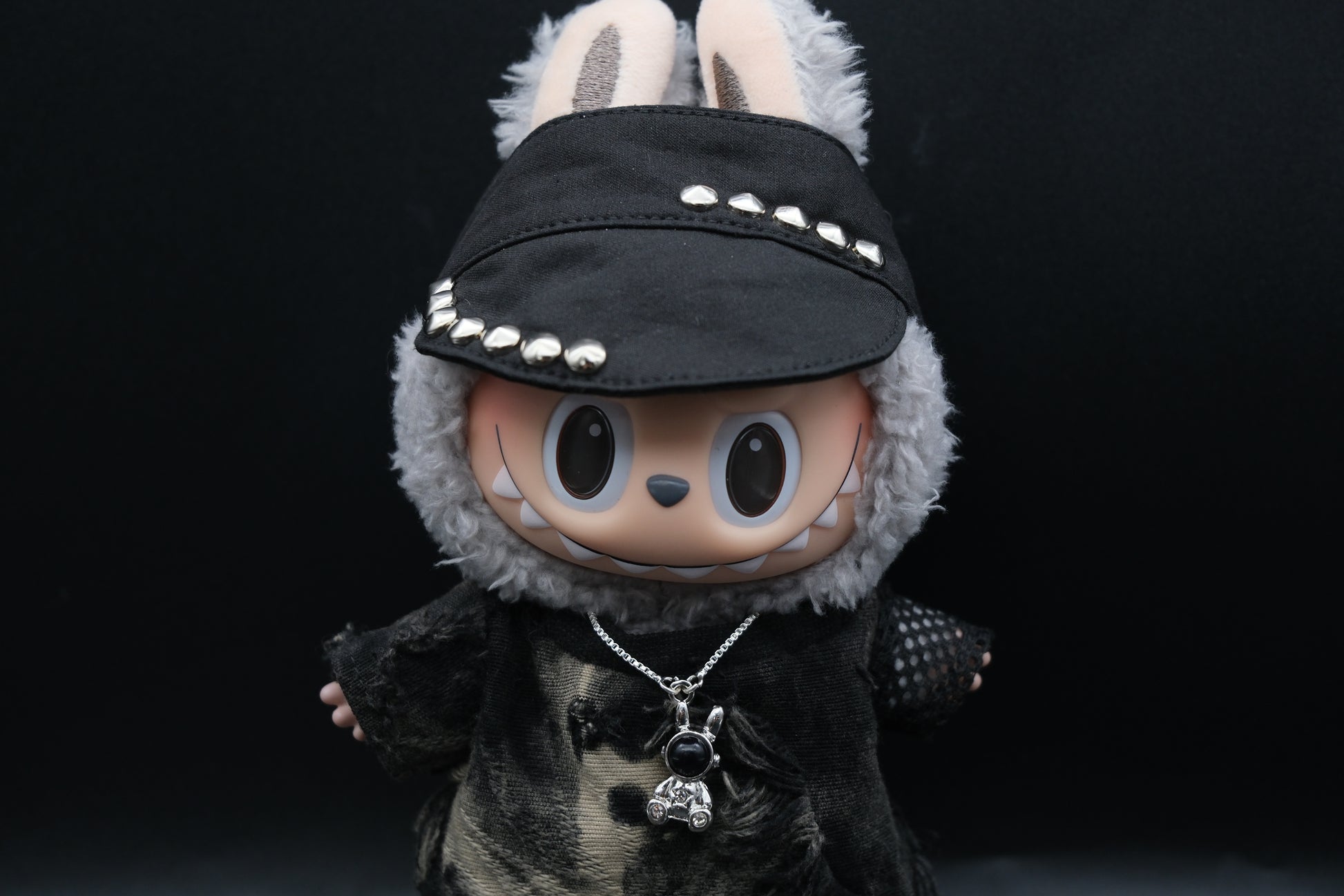  Labubu designer toy figure showcasing a modern streetwear look, featuring a punk hat , a black mixed dyeing distressed T-shirt,