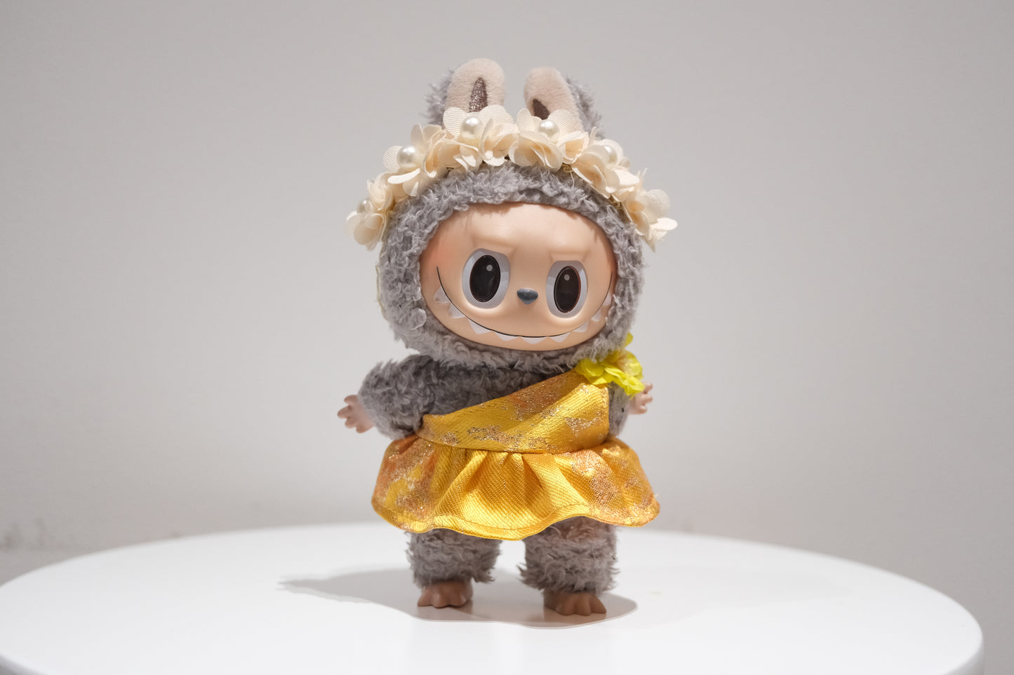 Labubu figure wearing a 2-piece yellow evening gown and pearl flower crown set, inspired by Judy Hopps