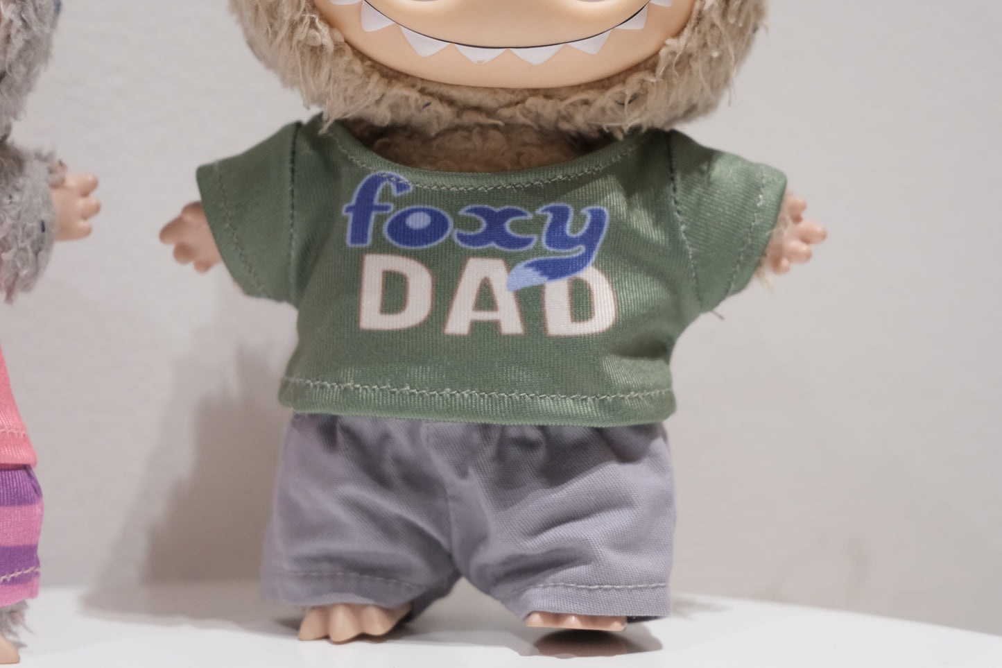 Front view of the Labubu Nick Wilde figure in the green t-shirt and grey pants outfit
