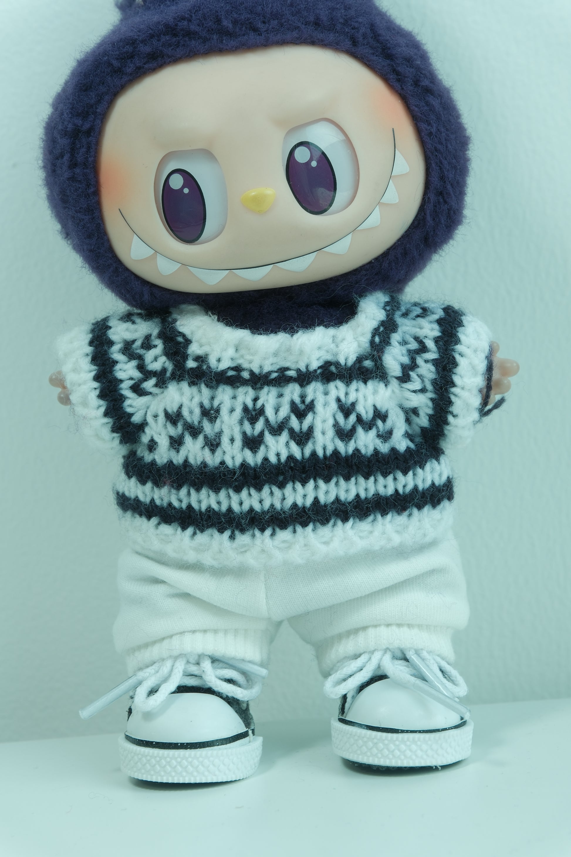 Close-up of The Monsters figure's high-contrast black and white graphic knit sweater