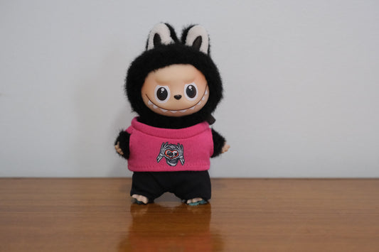 Labubu pin for love figure wearing a hot pink sweater with a skull and heart graphic