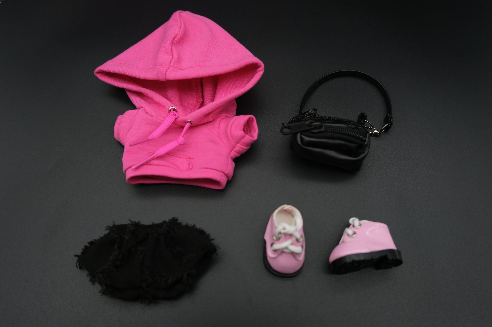 Labubu's a pink hoodie, black pants,  crossbody bag and pink sneakers.