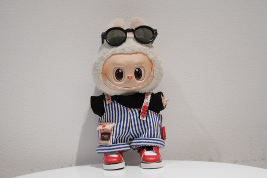 Labubu figure wearing a 4-piece retro streetwear outfit with blue and white striped dungarees, sunglasses, and red high-top sneakers