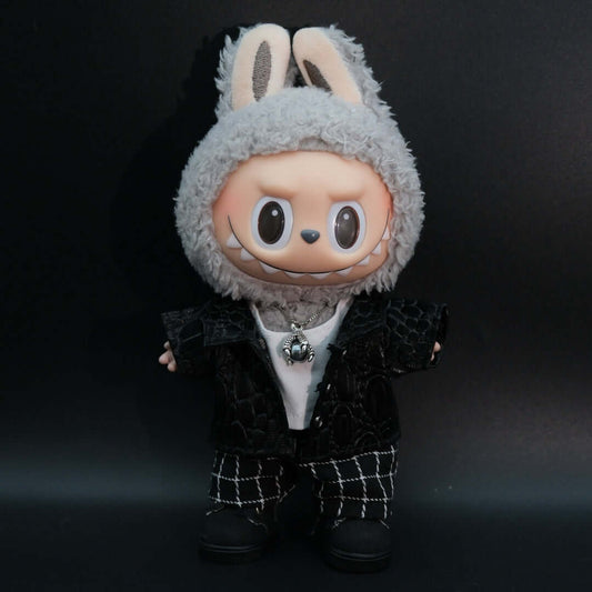 A Labubu wearing a dark leather jacket a white t-shirt, dark denim pants, and black sneakers