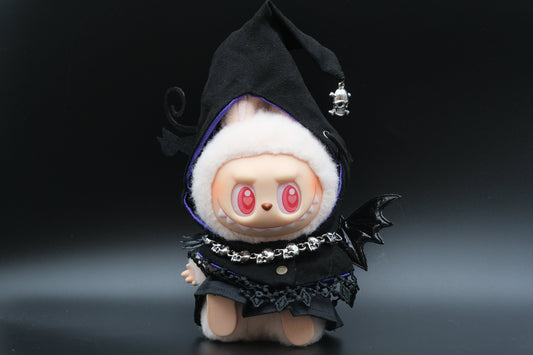 A Labubu figure wearing a 4-piece spooky streetwear outfit, including a black hoodie, a white dress, and a pumpkin mask.