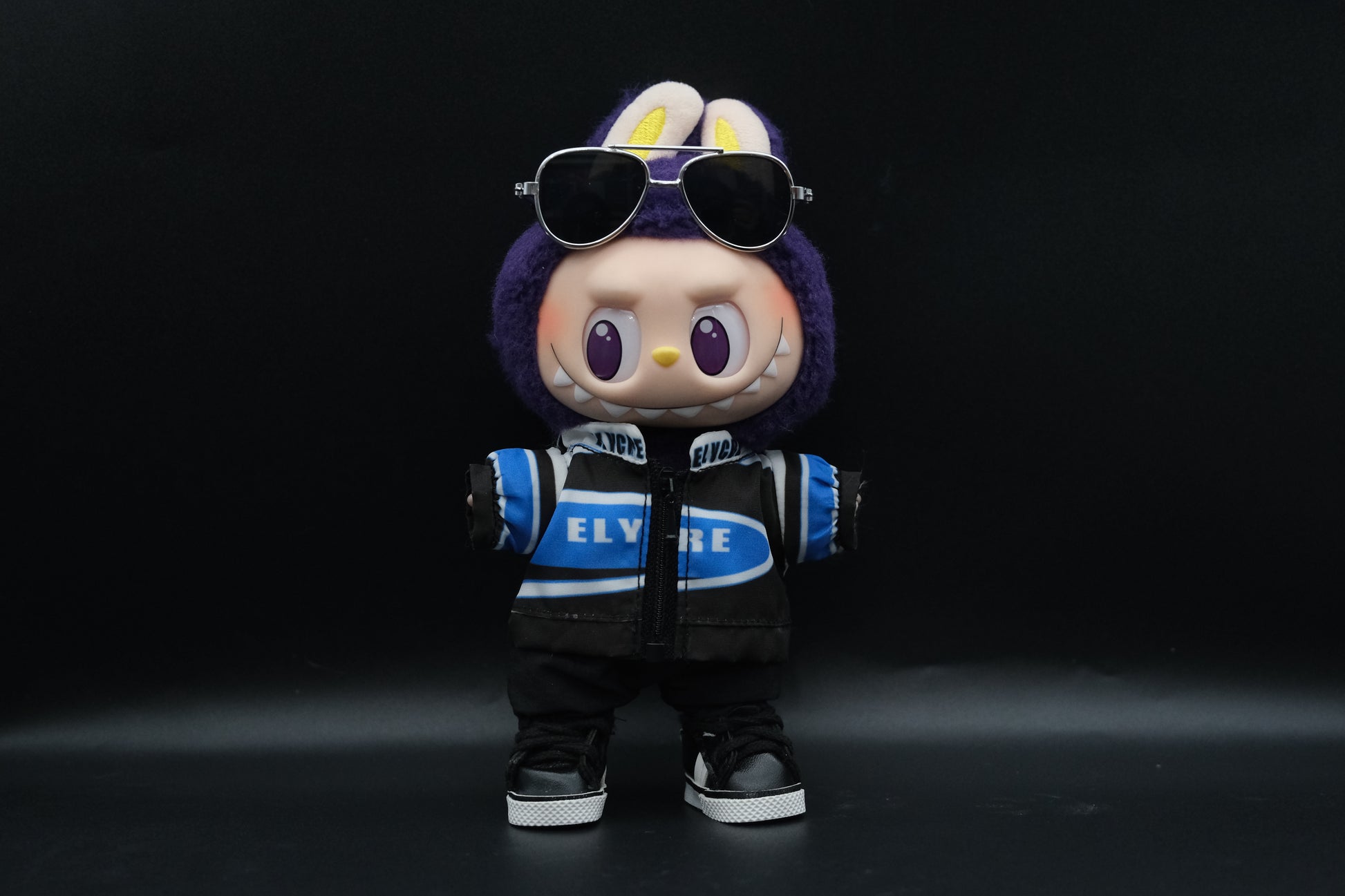 Labubu Vintage Sport Outfit including racing jacket, black pants, shoes and sunglasses