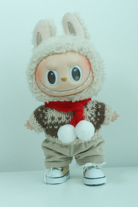 Labubu figure wearing a 4-piece rustic holiday outfit with a brown Fair Isle sweater, red pom-pom scarf, tan pants, and sneakers